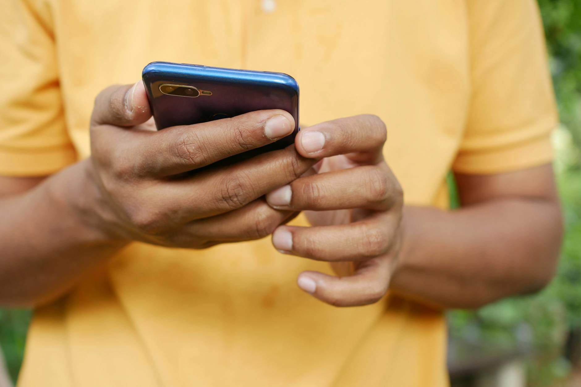 person holding blue smartphone